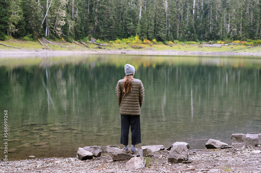 Female Standing In Front of Colorful Alpine Lake Female Standing In Front of Colorful Alpine Lake