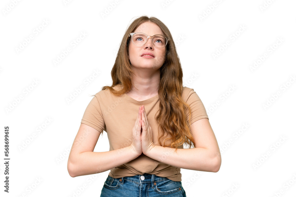 Young pretty woman over isolated background keeps palm together. Person asks for something Young pretty woman over isolated background keeps palm together. Person asks for something