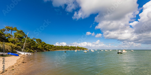 France, Nouvelle-Aquitaine, Les Portes-en-Re, Summer clouds over boats floating near shore of Ile de Re island photo