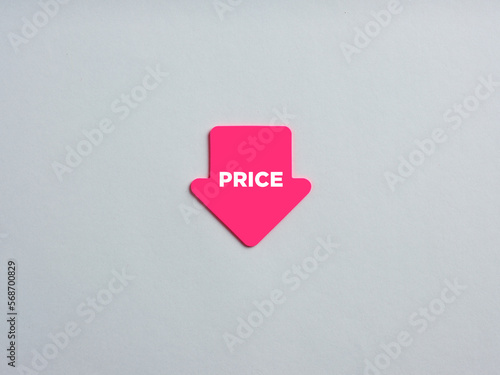 Prices are going down or decreasing. Arrow shaped note paper with the word price. photo