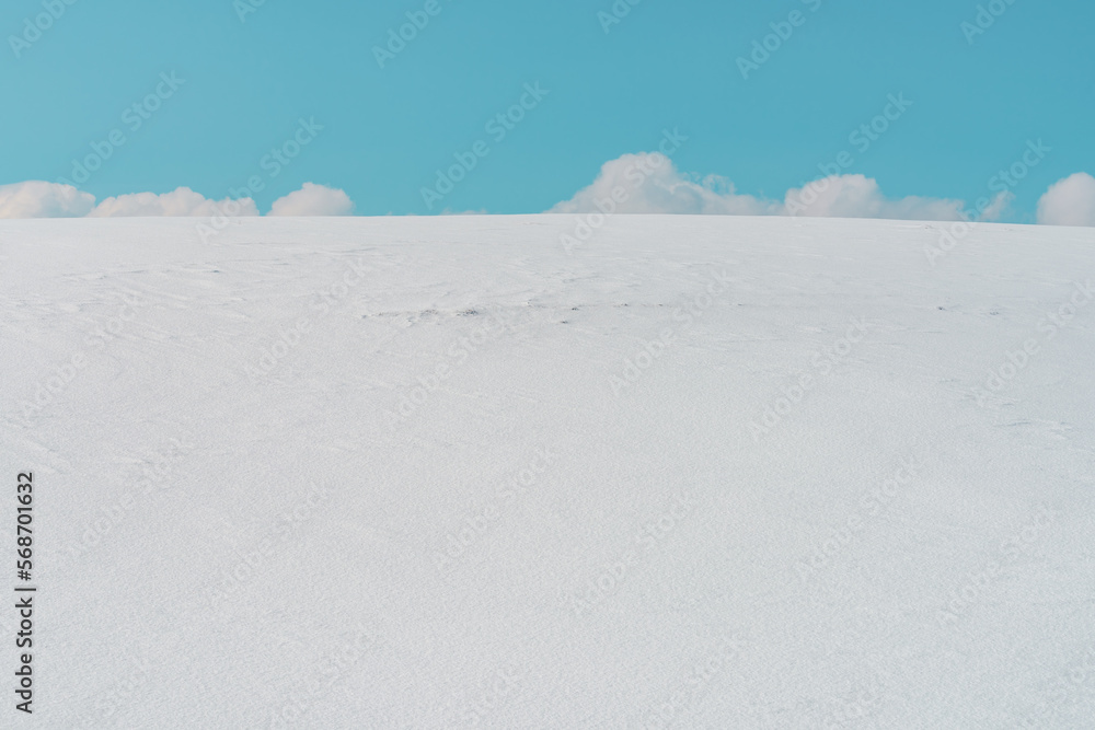 White clouds at sky behind the snow-capped hill in winter at Zlatibor, Serbia