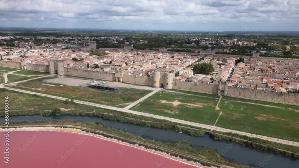 Drone shot of a old town in France with a pink sea in front of it Drone shot of a old town in France with a pink sea in front of it