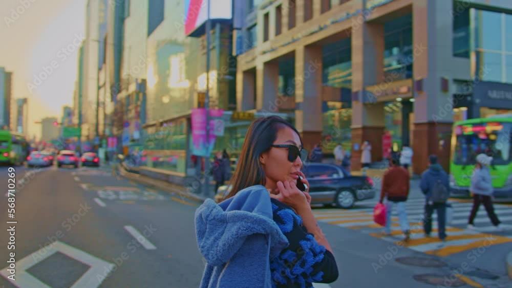 beautiful Asian oriental female girl woman model in big city town urban street area with sunglasses and cellphone talking and walking crossing road beautiful Asian oriental female girl woman model in big city town urban street area with sunglasses and cellphone talking and walking crossing road