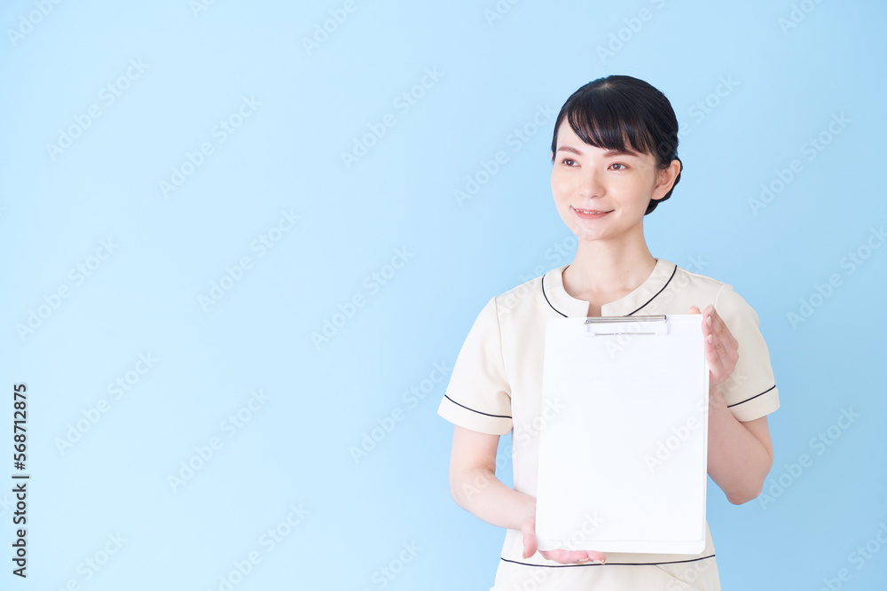 書類を見せるエステ・美容クリニックの女性