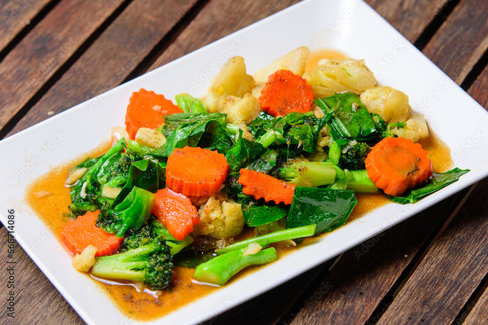 Fried stri mixed vegatable with oyster sauce on the white dish. Fried stri mixed vegatable with oyster sauce on the white dish.