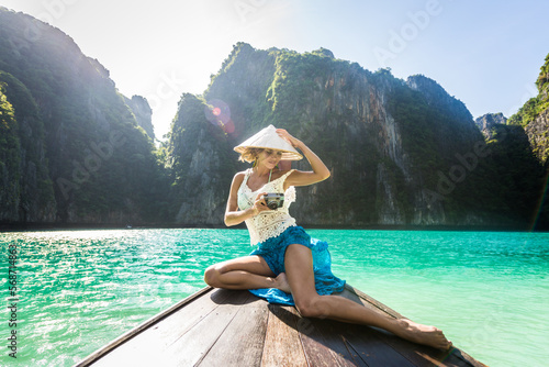 Beautiful woman on a long-tail boat in Thailand - Tourist visiting tropical island on south-east Asia, concepts about lifestyle and travel © oneinchpunch
