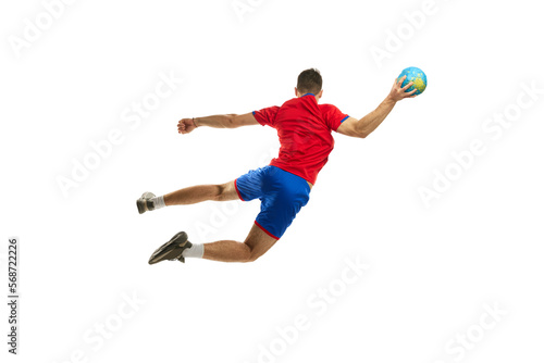 Back view studio shot in motion of young man, professional handball player training, playing isolated on white background. Dynamics. Concept of sport, action, motion, championship, sportive lifestyle