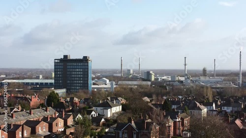 Aerial view over park trees to St Helens industrial townscape with blue skyscraper, Merseyside, England photo