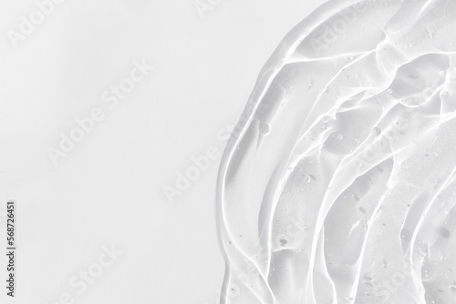 Transparent serum or gel with hyaluronic acid for the face on a white background. Textured background with oxygen bubbles. Wellness and beauty concept.