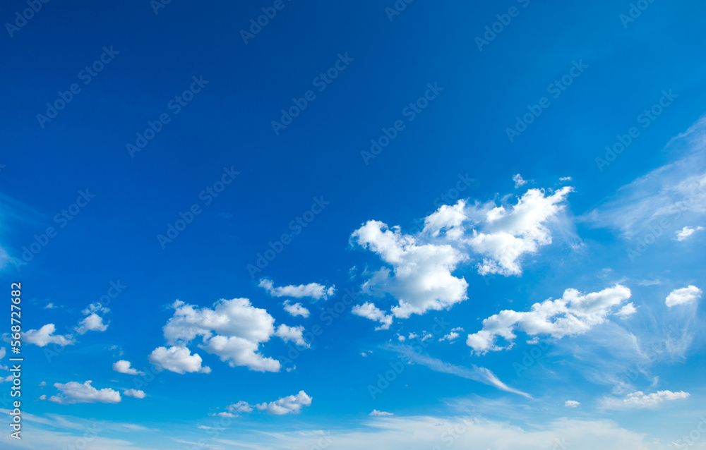 white fluffy clouds with rainbow in the blue sky white fluffy clouds with rainbow in the blue sky
