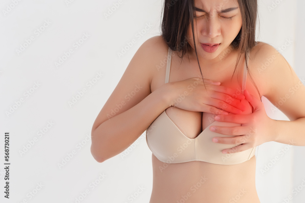 Female breast pain hand touching her breast screening by self. woman