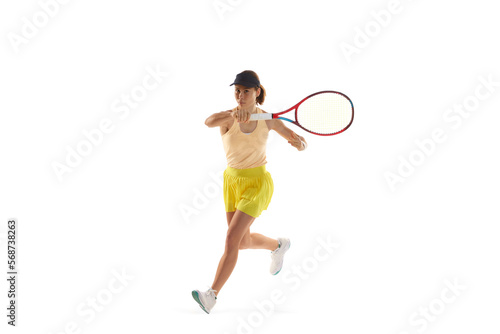 One young teen girl, tennis player in sports uniform playing tennis isolated over white background. Concept of sport, fashion, motivation, education and achievement © Lustre