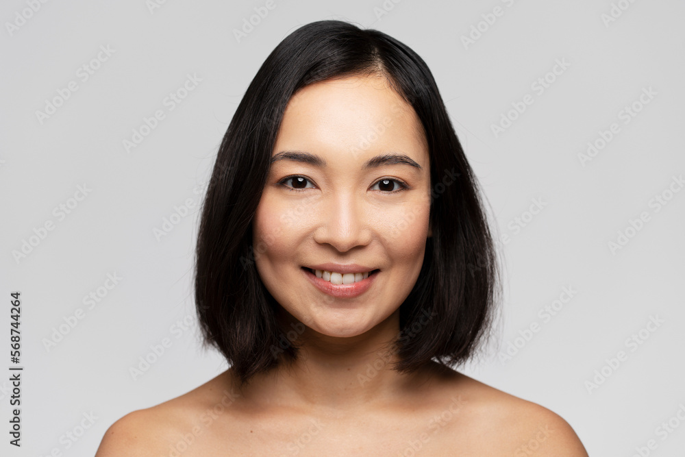 Portrait of smiling girl enjoying beauty treatment on white background Portrait of smiling girl enjoying beauty treatment on white background