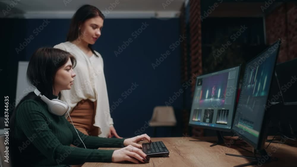 video editor and director women discussing final cut of movie or musical clip in studio, teamwork video editor and director women discussing final cut of movie or musical clip in studio, teamwork