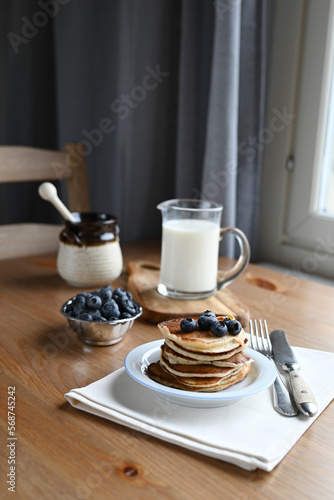 delicious homemade pancakes with blueberries on wooden background