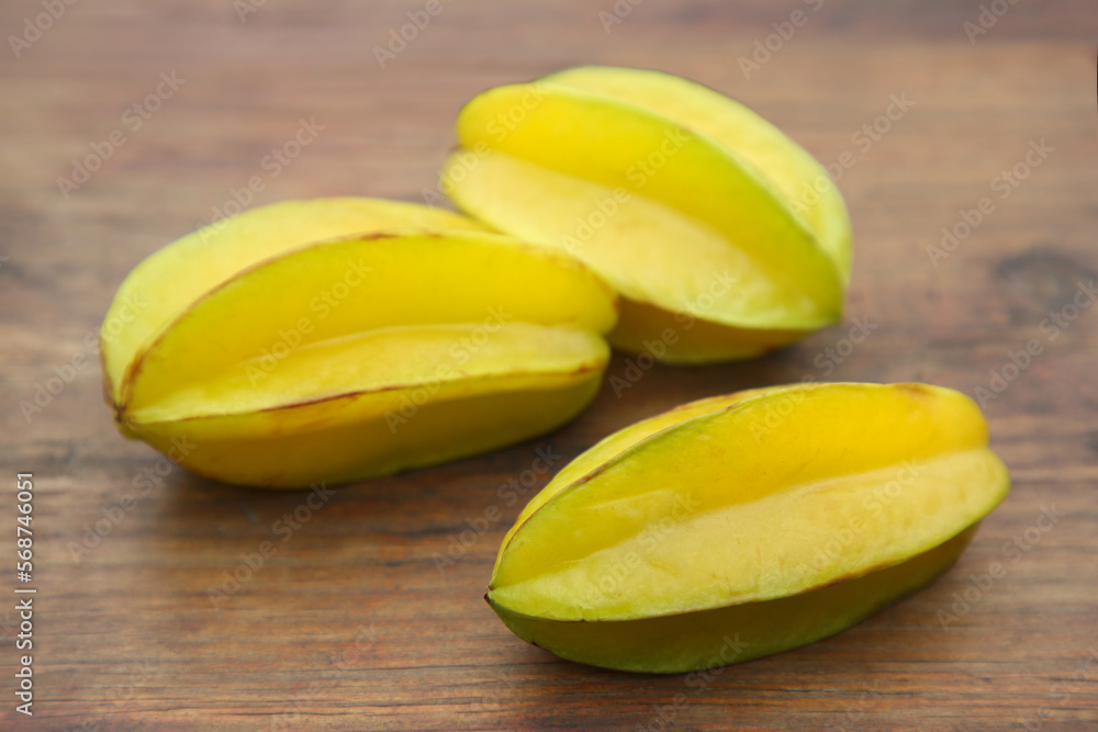 Delicious ripe carambolas on wooden table, closeup Delicious ripe carambolas on wooden table, closeup