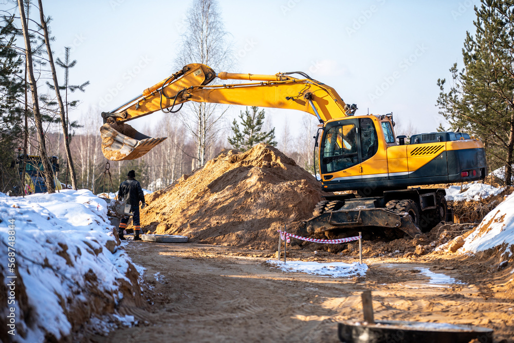 the process of loosening frozen winter soil with an excavator bucket the process of loosening frozen winter soil with an excavator bucket