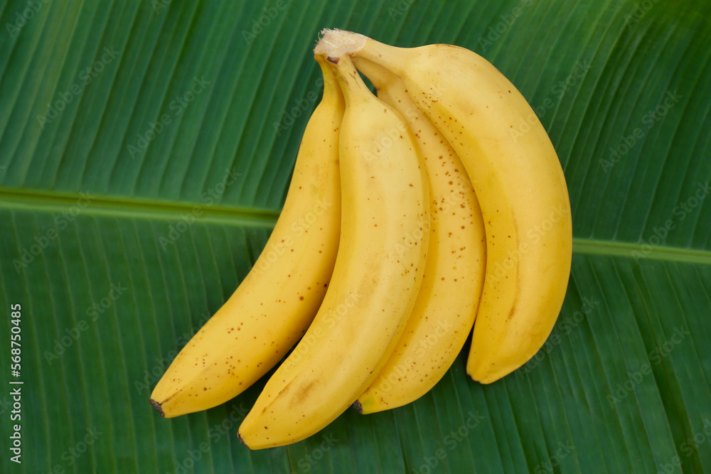 Delicious bananas on green leaf, top view