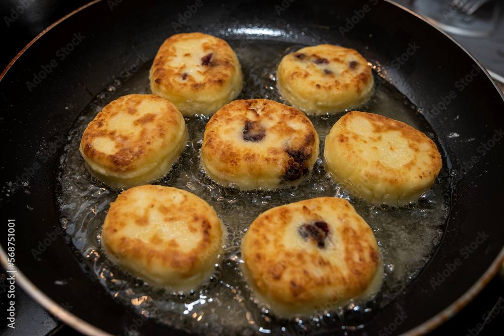 fresh tasty cheese pancakes cheesecakes are fried in a pan, ukraine traditional food fresh tasty cheese pancakes cheesecakes are fried in a pan, ukraine traditional food