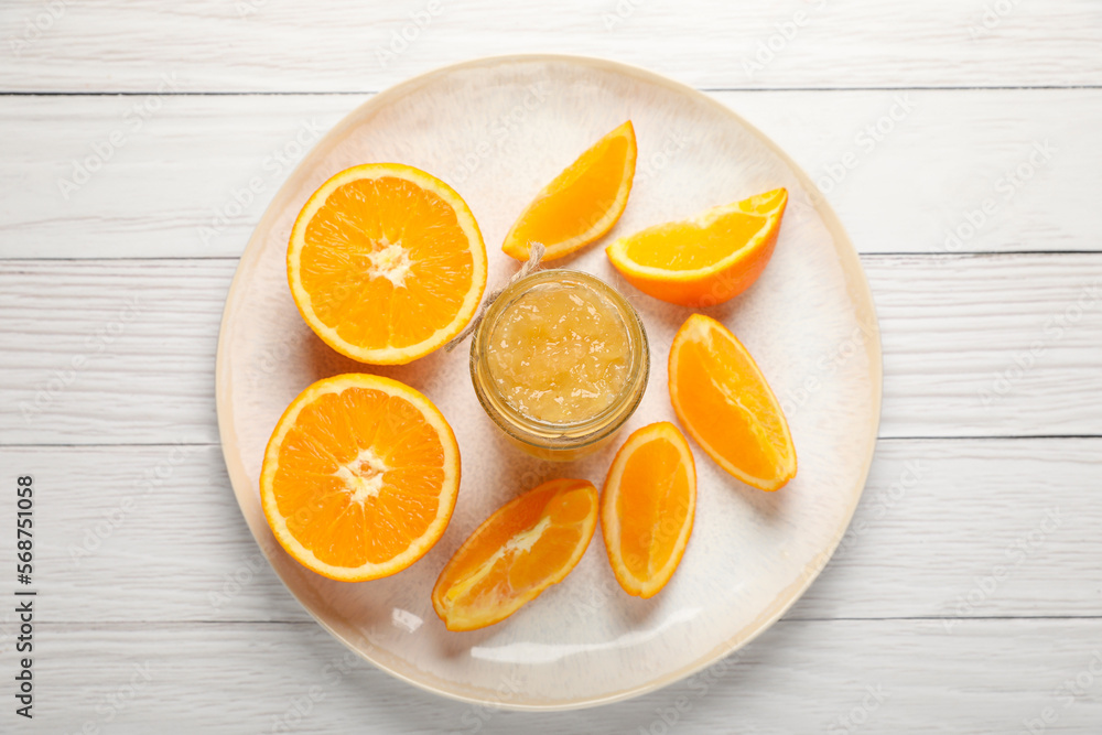 Jar of delicious orange jam and fresh fruits on white wooden table, top view Jar of delicious orange jam and fresh fruits on white wooden table, top view