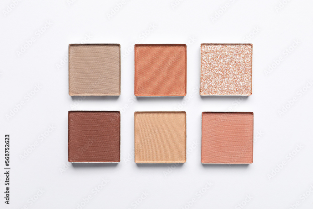 Fototapeta premium Beautiful eye shadow refill pans on white background, flat lay