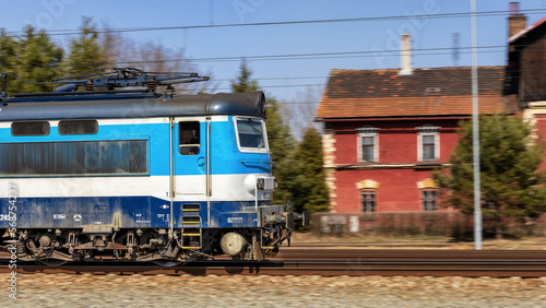 A fast moving train leaves the station.