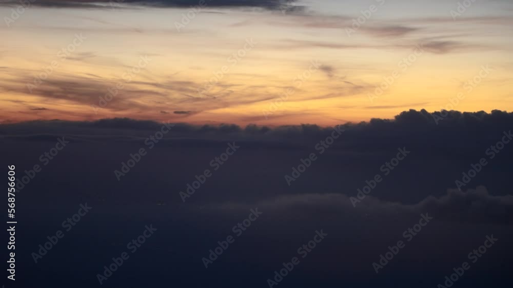 Aerial shot of Clouds during sunset, blue hour, view from airplane window