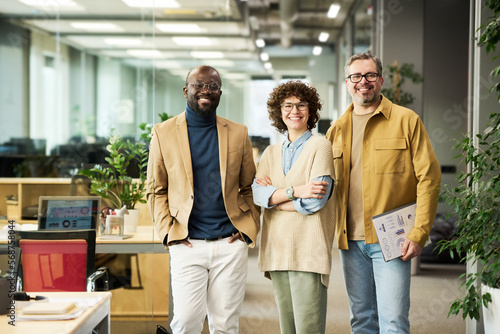 Quadro su tela Three successful managers or brokers in smart casualwear looking at camera while