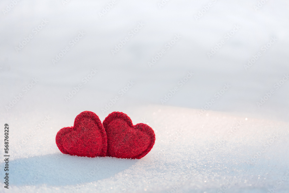 Fototapeta premium two hearts together on a white snow. In love, Valentine's Day, February 14 postcard