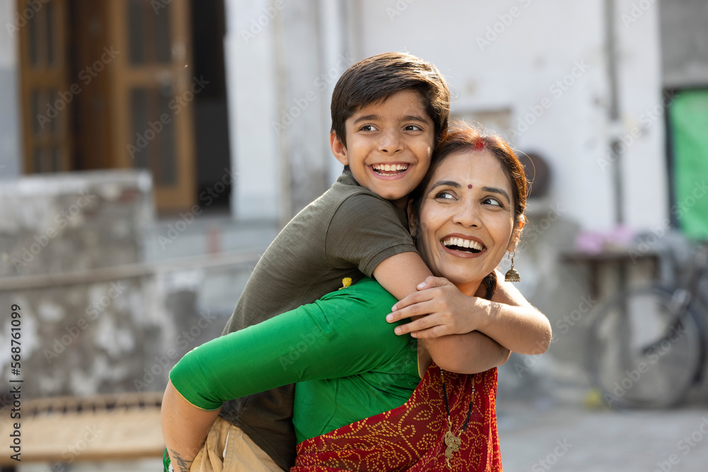 Naklejka premium Boy embracing his loving mother at home.