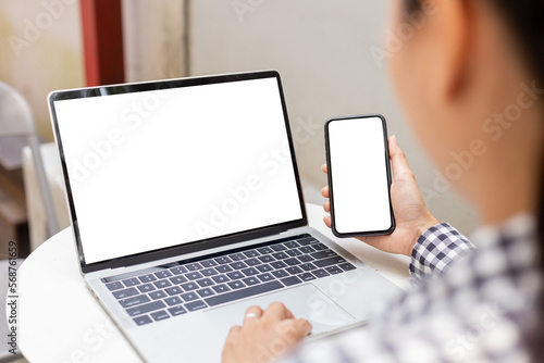 computer screen,cell phone blank mockup.hand woman work using laptop texting mobile.white background for advertising,contact business search information on desk in cafe.marketing,design