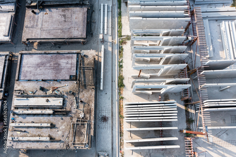 Aerial top view of Precast concrete wall panel for construction building site in warehouse factory. Precast concrete manufacturing products on prefabricated house factory Aerial top view of Precast concrete wall panel for construction building site in warehouse factory. Precast concrete manufacturing products on prefabricated house factory