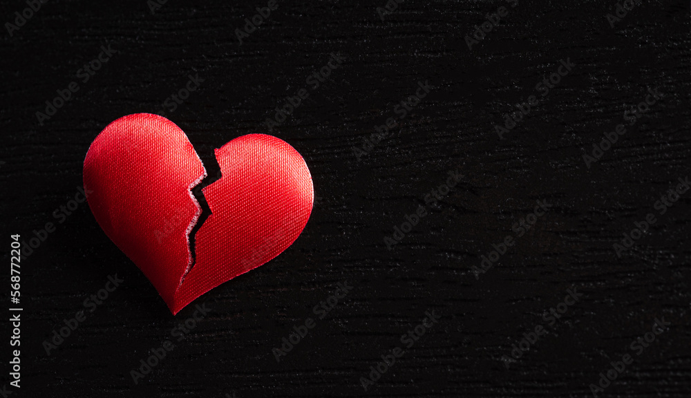 Broken red heart on black wooden background. Heart broken, Love and Valentines day concept. Broken red heart on black wooden background. Heart broken, Love and Valentines day concept.
