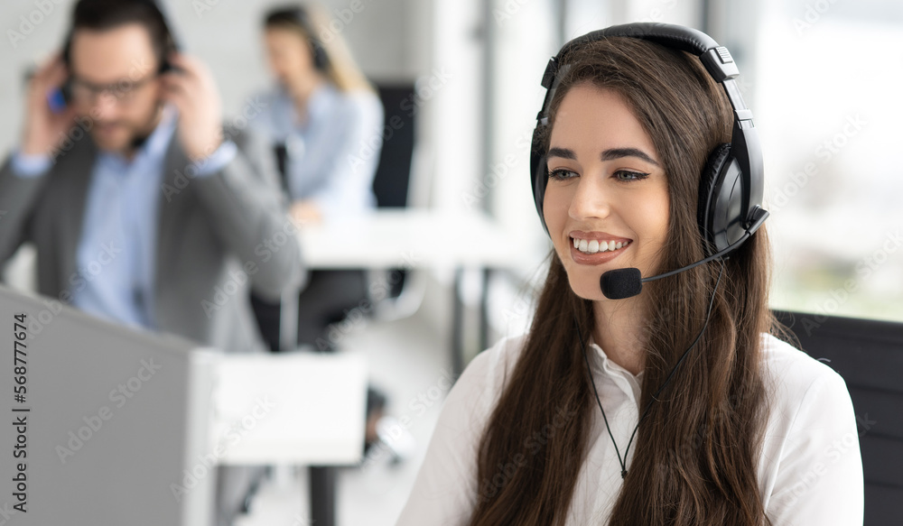 Close up portrait of friendly smiling customer support operator female working at helpdesk office Close up portrait of friendly smiling customer support operator female working at helpdesk office