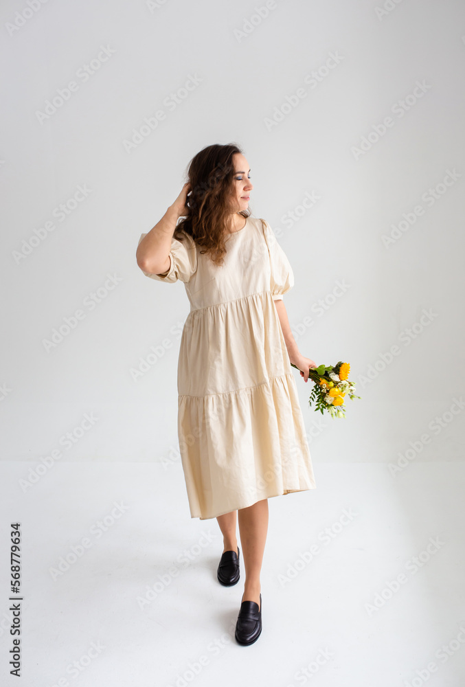 Beautiful woman with spring yellow bouquet of flowers spring and beauty concept Beautiful woman with spring yellow bouquet of flowers spring and beauty concept