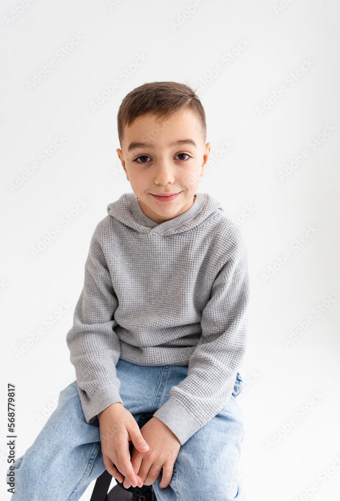 Boy child preschooler smiling and posing on gray background in photo studio Boy child preschooler smiling and posing on gray background in photo studio