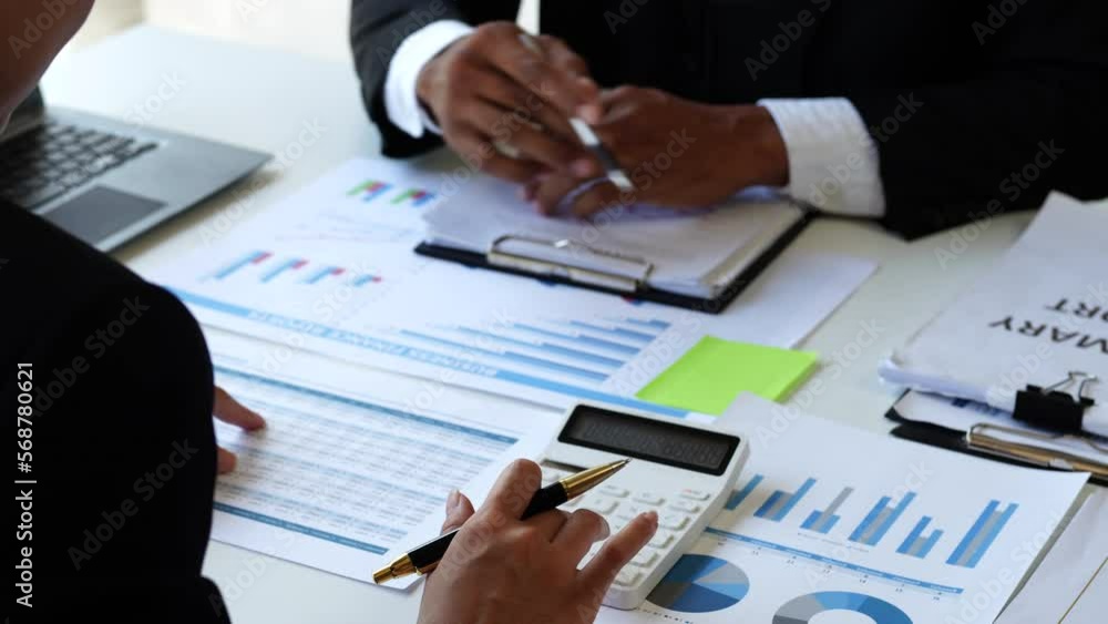 Accounting team manager working with cash flow chart and balance sheet, asset paperwork with stock market monthly statics Accounting team manager working with cash flow chart and balance sheet, asset paperwork with stock market monthly statics