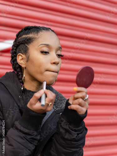 Young woman applying make-up