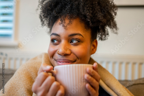 Young woman relaxing with cup of tea