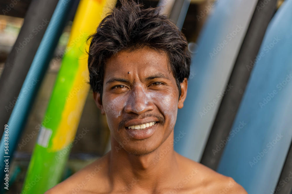 Obraz premium Portrait of smiling surfer with sun lotion on face