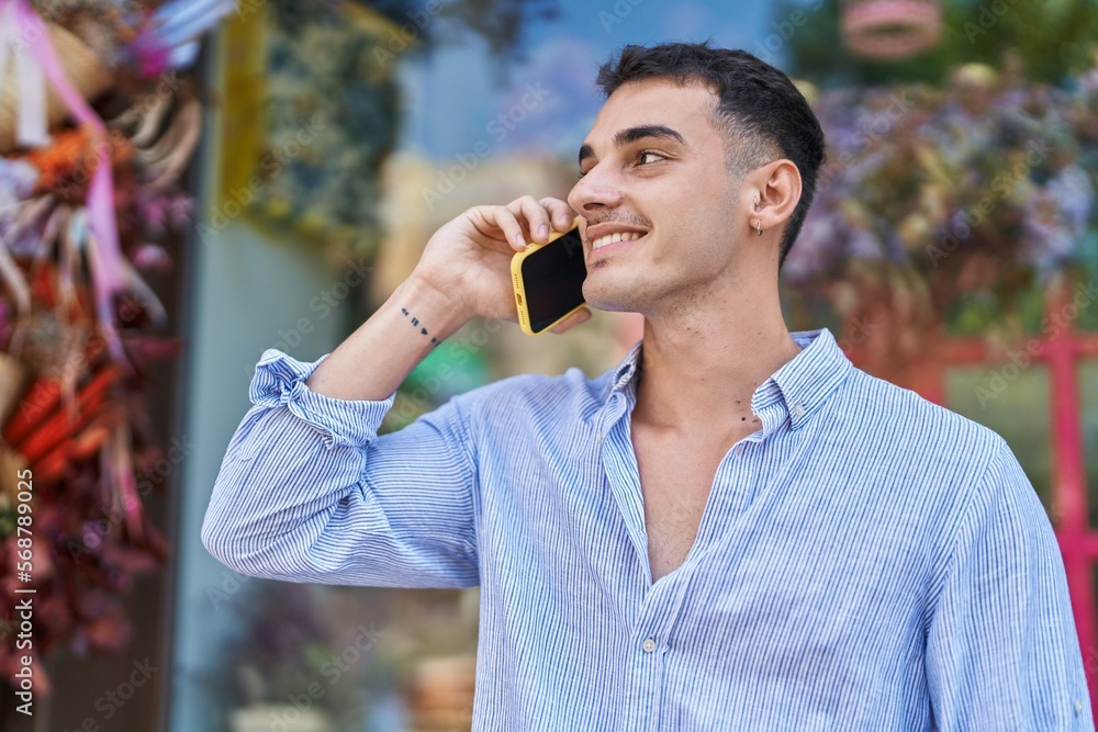 Young hispanic man smiling confident talking on the smartphone at street Young hispanic man smiling confident talking on the smartphone at street