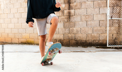 A boy skates in a hoodie and shorts with dog Practice freestyle extreme Sports