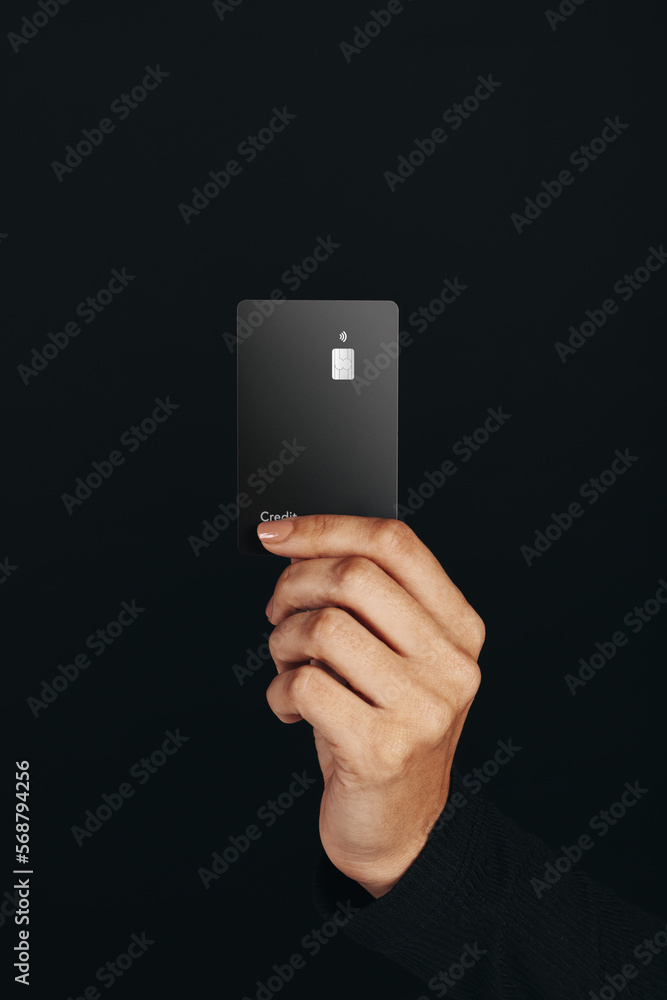 © Jacob Lund - Premium banking with a contactless card: Hand holding a black credit card in a studio © Jacob Lund - Premium banking with a contactless card: Hand holding a black credit card in a studio