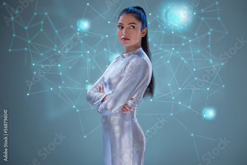 A woman wearing silver futuristic clothes with virtual icons in the background , future technology concept