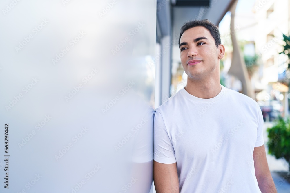 Young hispanic man smiling confident standing at street Young hispanic man smiling confident standing at street