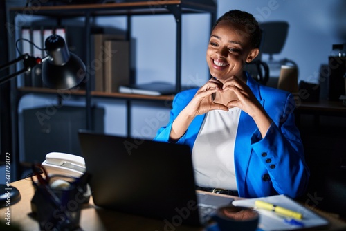 Wallpaper Mural Beautiful african american woman working at the office at night smiling in love doing heart symbol shape with hands. romantic concept. Torontodigital.ca