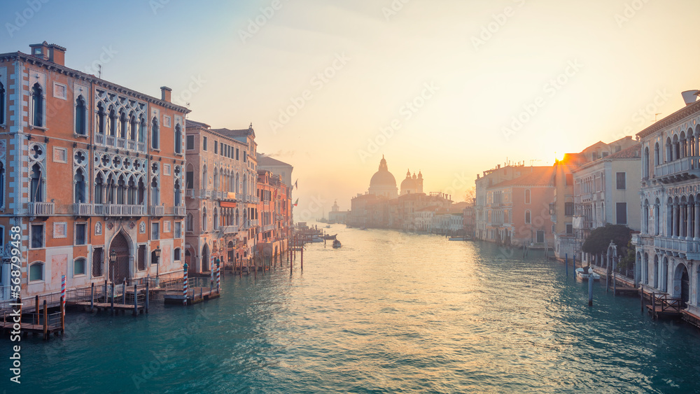 Venice, Italy. Cityscape image of Grand Canal in Venice, with Santa Maria della Salute Basilica in the background at winter sunrise.