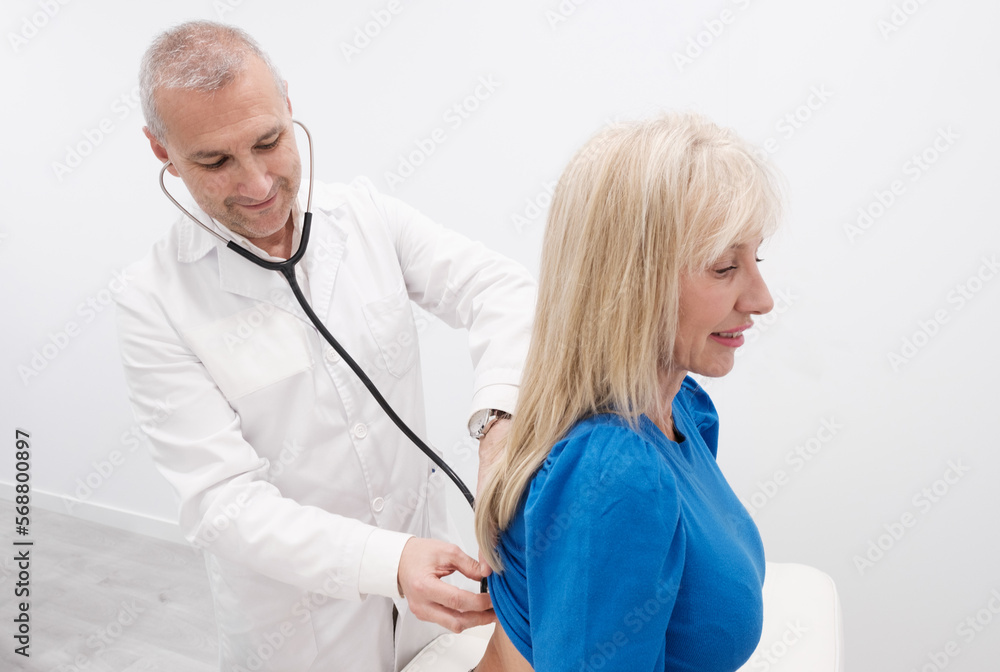 Male Doctor Checks Mature Patient Woman with Stethoscope Male Doctor Checks Mature Patient Woman with Stethoscope