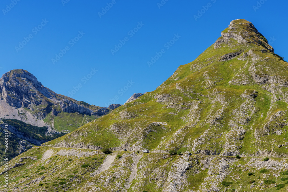 The road between the mountains. Dangerous mountain road. Sunny day, blue sky. The road between the mountains. Dangerous mountain road. Sunny day, blue sky.
