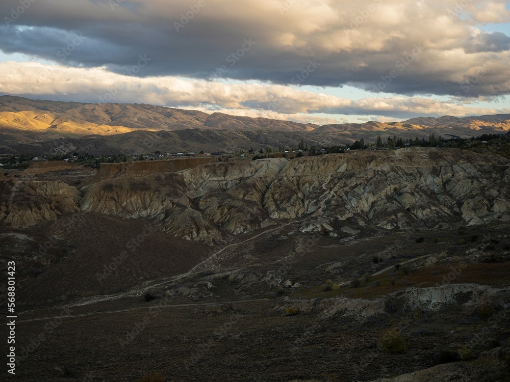 Arid barren badland, wild west desert landscape of Bannockburn Sluicings in former goldmine in Central Otago New Zealand